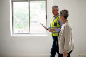 A property inspector walks through a house with the homeowner.